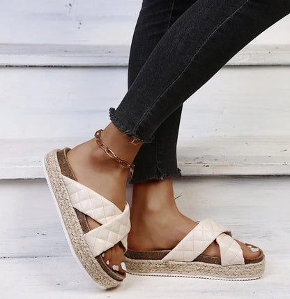Elegant cross-toe platform sandals and slippers in a neutral creamy white hue, showcasing a contemporary and refined design for the discerning woman