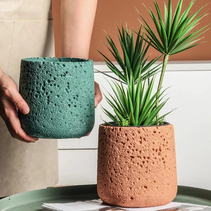 A modern, perforated cement bonsai planter in a Nordic-inspired design, available in various sizes and colours.