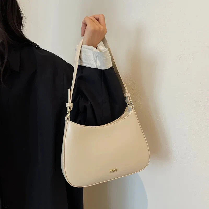 Luxury red leather crossbody bag with sleek design and elegant details