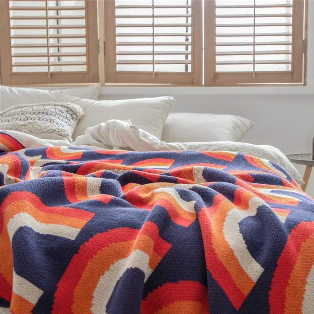 Cosy and vibrant 100% cotton knit throw blanket with a colourful rainbow pattern