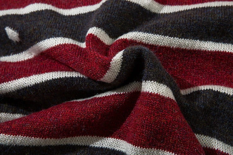 A cosy and stylish jumper featuring a patchwork design with contrasting stripes in a classic British colour palette.