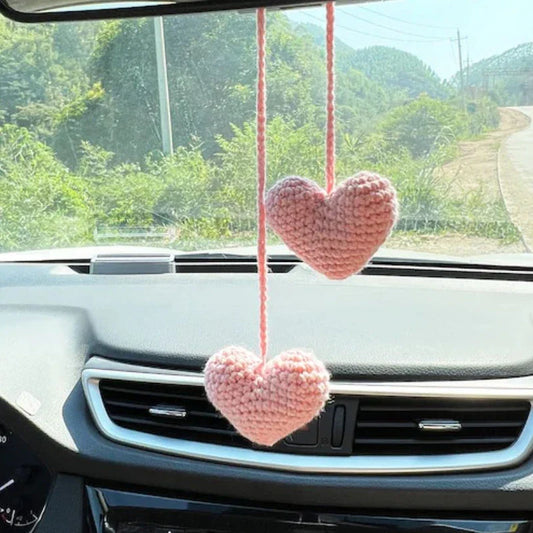 Charming knitted car plant decor with hanging white rope and green and white colour scheme