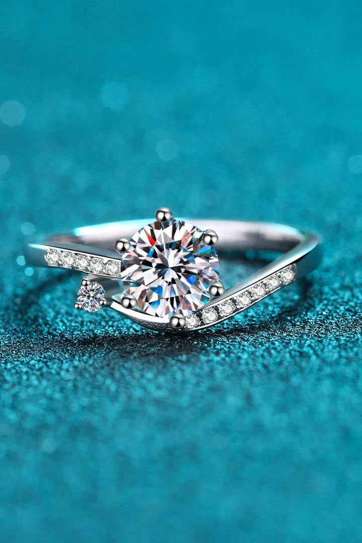 Elegant Moissanite and Sterling Silver Ring with a sparkling centre stone, delicate zircon accents, and a luxurious 925 sterling silver setting