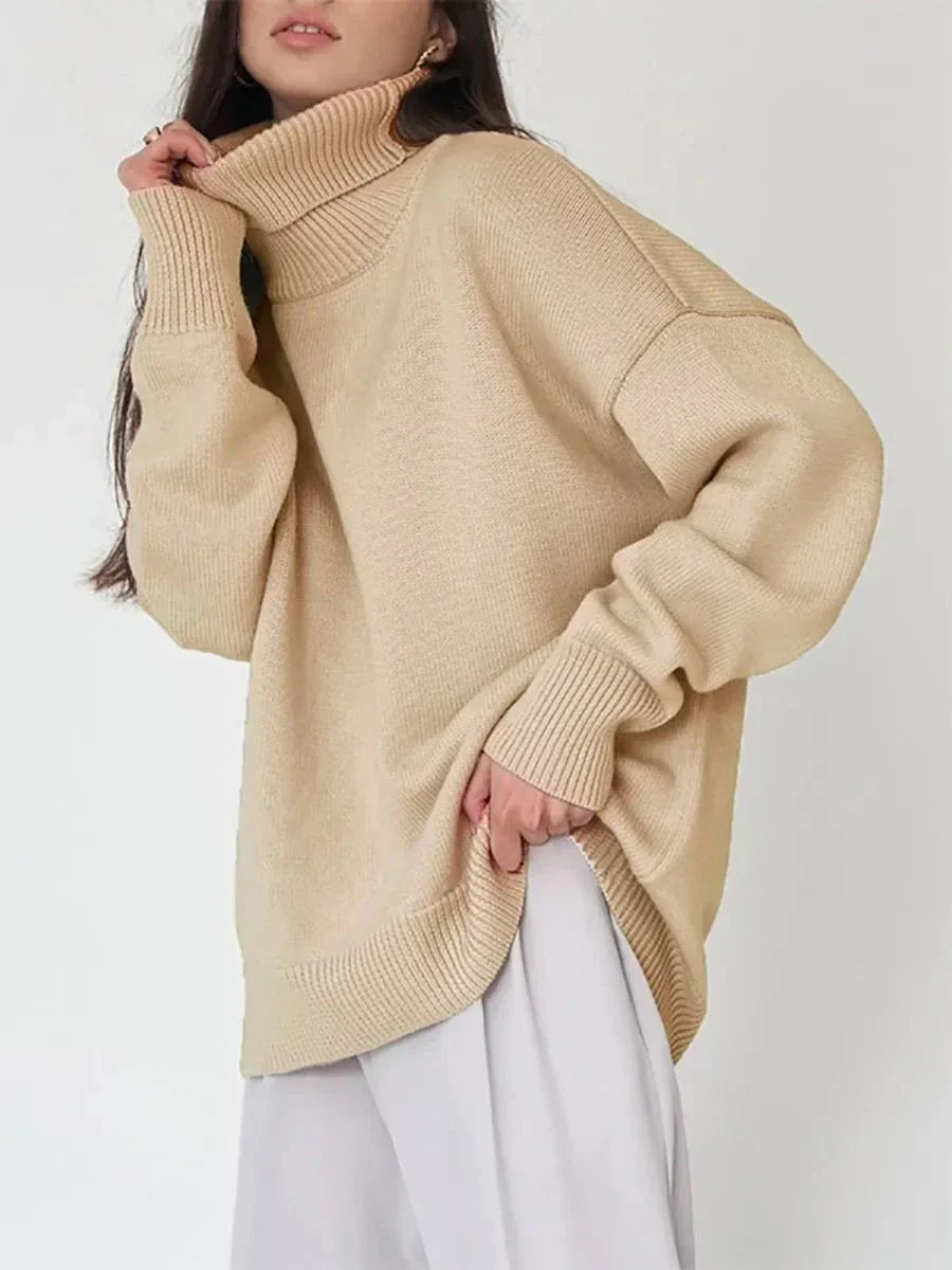 Cosy oversized knitted pullover in blue, featuring a classic turtleneck collar and drop-shoulder silhouette for maximum comfort and style.