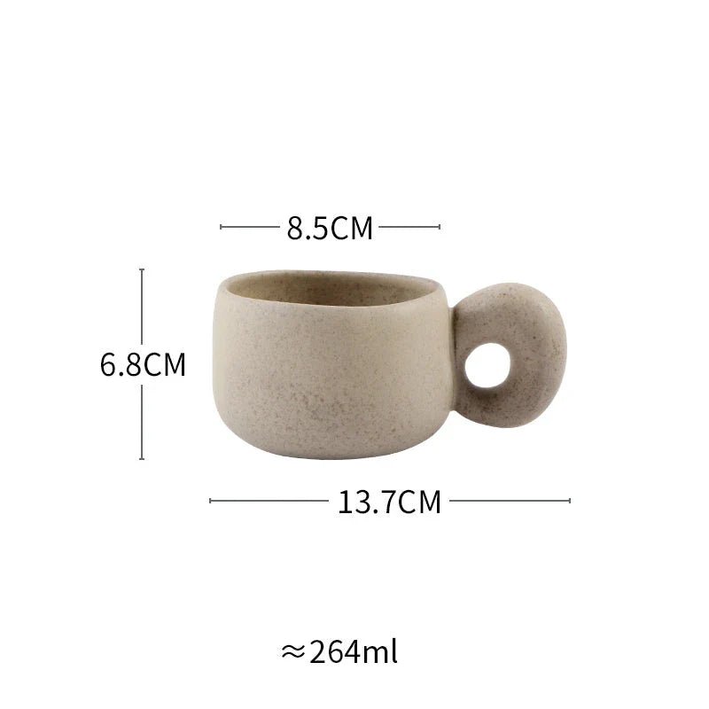 Handcrafted Japanese ceramic retro coffee mug in solid apricot or grey colour, featuring a comfortable handgrip design for enhanced daily beverage enjoyment.