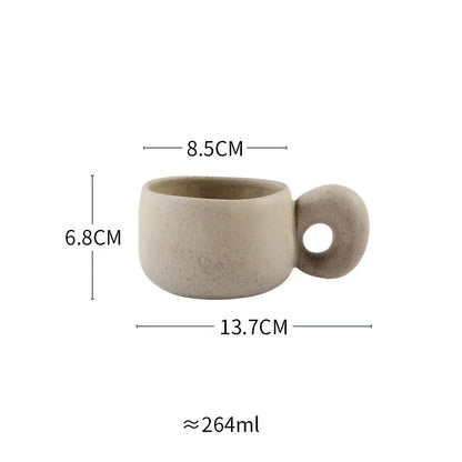 Handcrafted Japanese ceramic retro coffee mug in solid apricot or grey colour, featuring a comfortable handgrip design for enhanced daily beverage enjoyment.