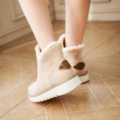 A pair of stylish, non-slip snow boots with a warm artificial wool lining, perfect for British winter weather