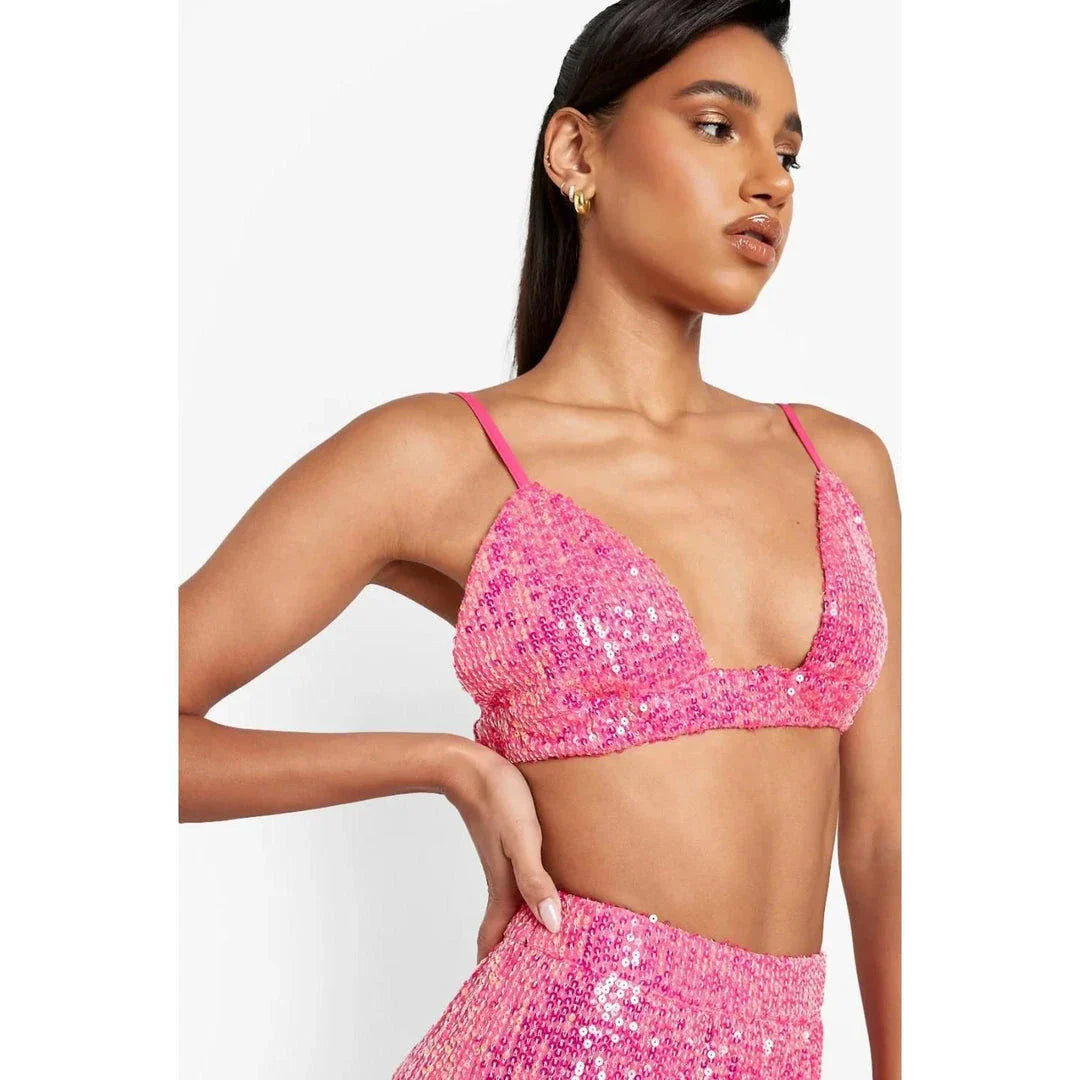 Elegant woman wearing a luxurious sequin top and pants set, perfect for a glamorous evening event