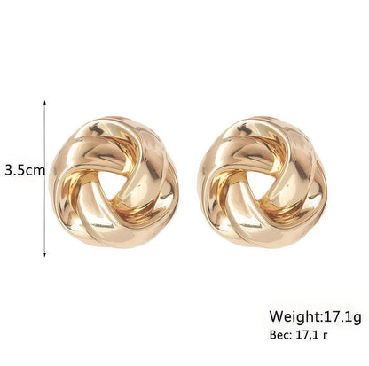 Pair of gold spiral drop earrings with an exaggerated, dramatic design for a bold, fashionable look