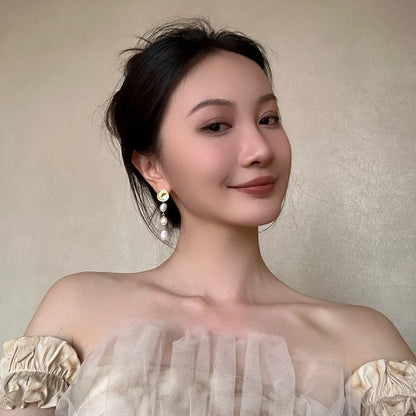 Elegant pearl and gold plated earrings with a long, eye-catching design