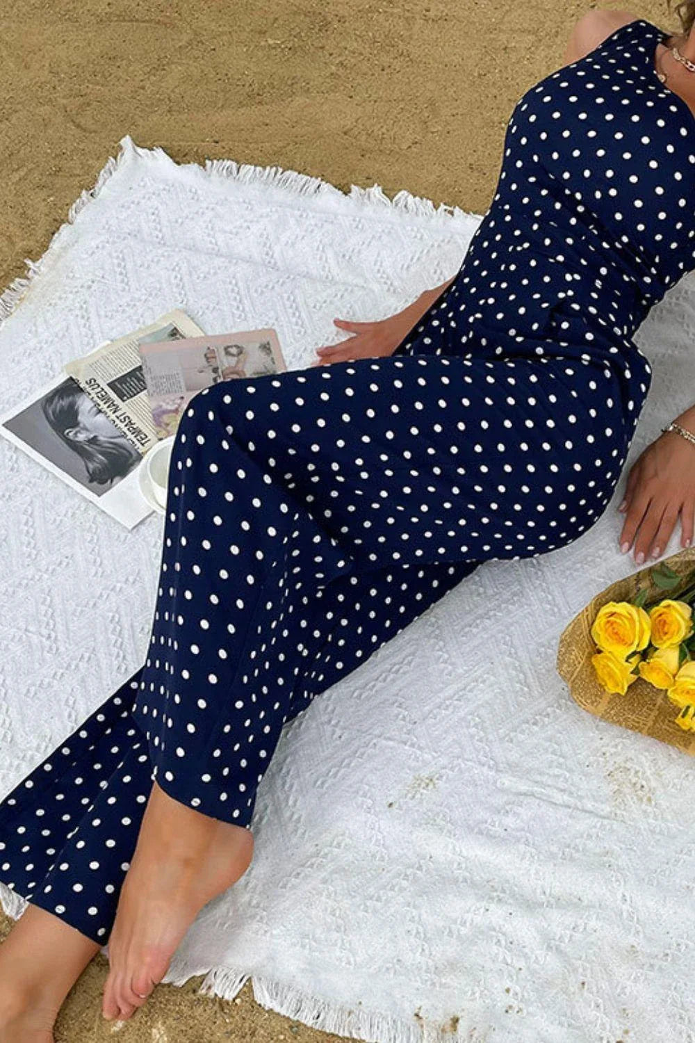 A stylish one-shoulder polka dot jumpsuit with a flattering, figure-hugging silhouette