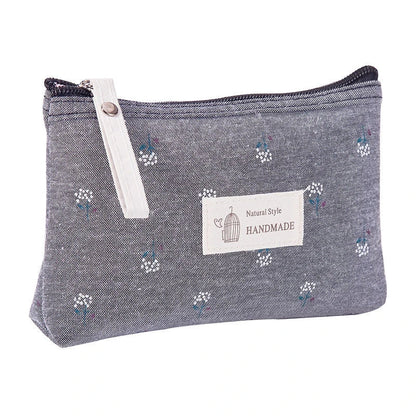 A stylish floral canvas cosmetic bag with a secure zipper closure, perfect for organising and carrying your makeup and toiletries while traveling.