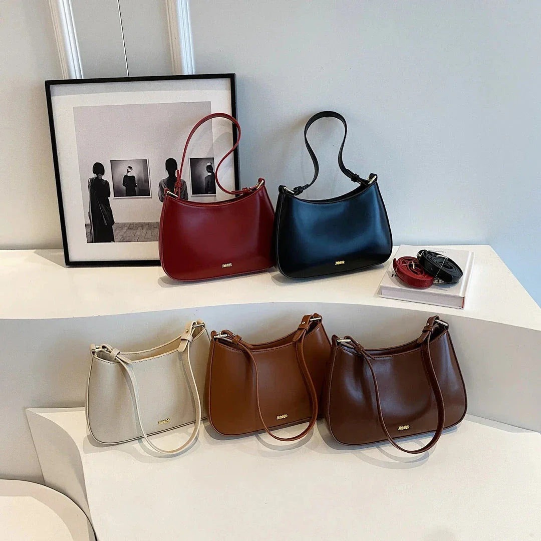 Luxury red leather crossbody bag with sleek design and elegant details