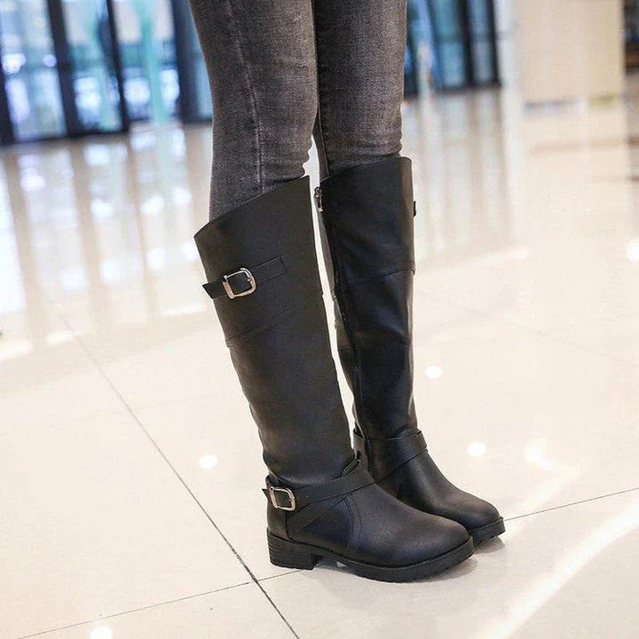 A pair of stylish women's low heel boots with a round toe design, available in black, brown, and army green colours.