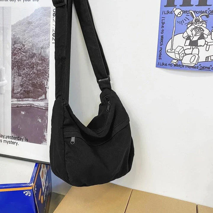 A stylish and durable canvas tote bag with a spacious interior and a timeless vintage-inspired design, perfect for everyday use and travel