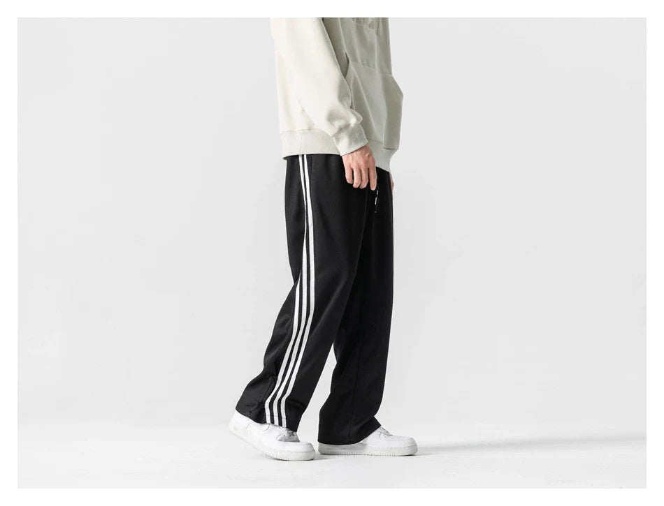Stylish striped sports trousers in a relaxed, mid-waist design for versatile leisure and athletic wear