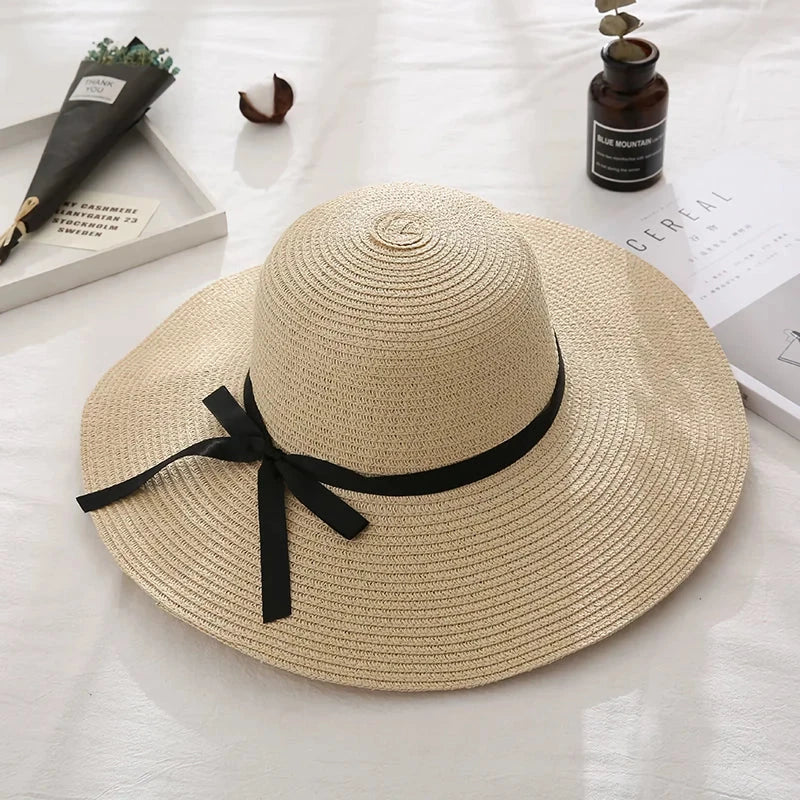 Fashionable straw hat for women with wide brim, foldable design, and stylish bow detail