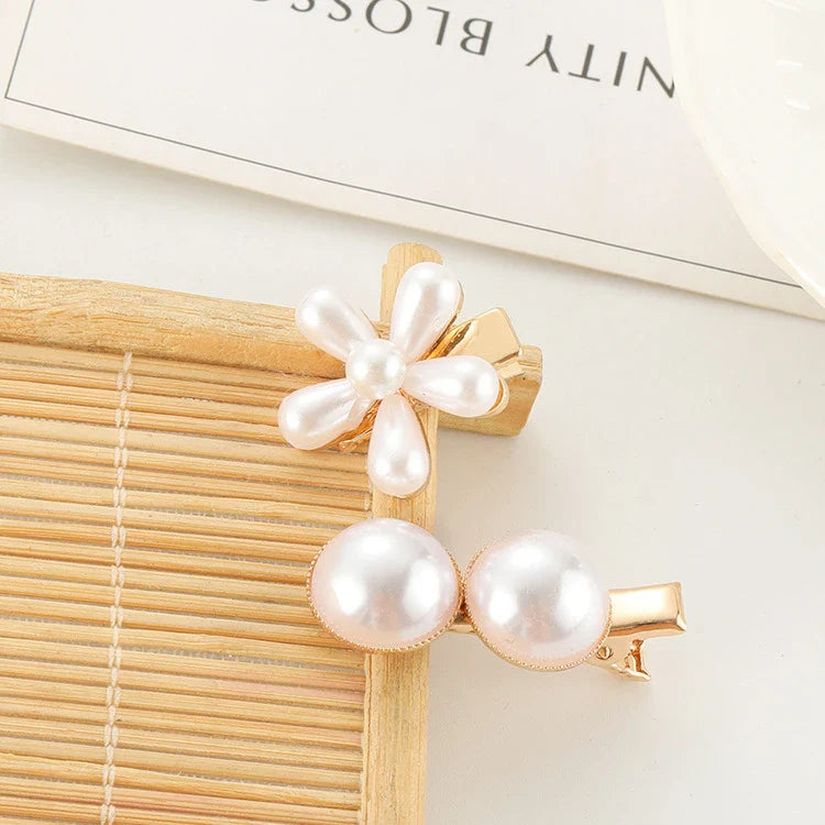 Elegant silver-toned hair clip with a beautiful pearl flower design, a timeless British-inspired accessory