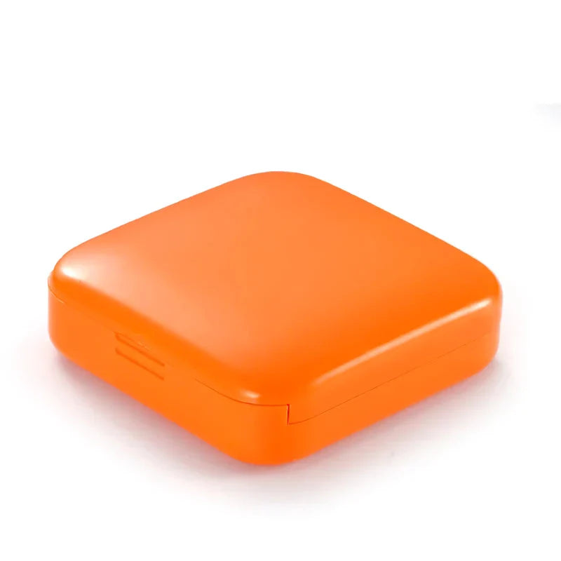Compact push-pull pill case organiser in various vibrant cartoon-inspired colours for convenient medication management