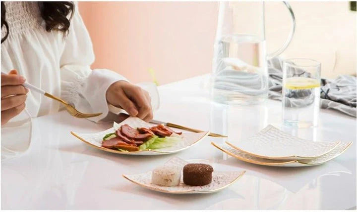 Elegant embossed ceramic cake plate in white, perfect for serving desserts and platters.