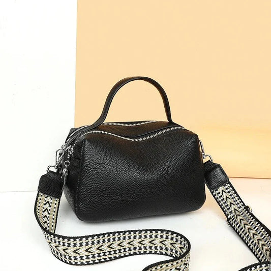Luxurious genuine leather crossbody bag for women, featuring a soft polyester lining, dual phone pockets, and a compact, square design.