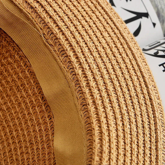 A classic summer Panama hat made from straw and paper, featuring a charming bow detail that adds a feminine touch.