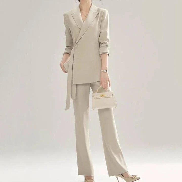 A two-piece vintage-inspired office suit with a long-sleeve blazer and high-waisted trousers, designed for the modern professional woman.