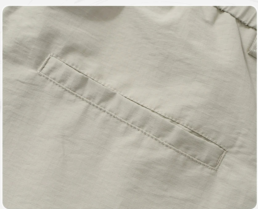 Premium men's quick-drying casual trousers in black, caramel, and sand colours with a relaxed, loose fit