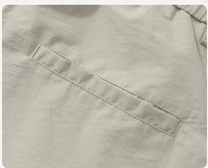 Premium men's quick-drying casual trousers in black, caramel, and sand colours with a relaxed, loose fit