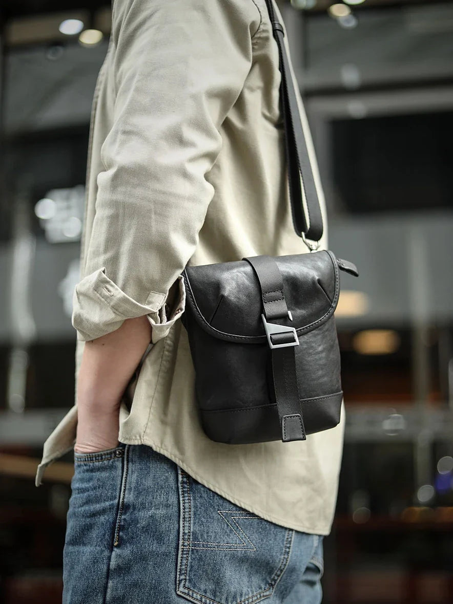 Premium cowhide leather shoulder sling bag with one-shoulder design and oblique paneling for modern British style