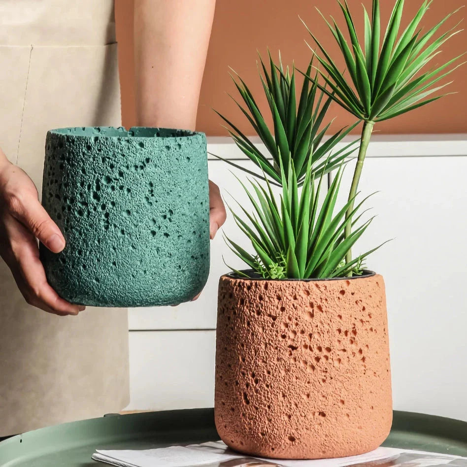 A modern, perforated cement bonsai planter in a Nordic-inspired design, available in various sizes and colours.