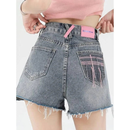 Stylish high-waisted denim shorts with subtle embroidery, perfect for summer fashion