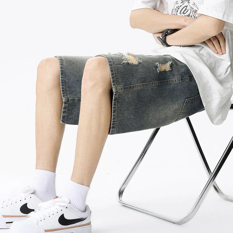 Premium British-crafted vintage-inspired ripped denim shorts for men with a straight-leg silhouette and authentic distressed details