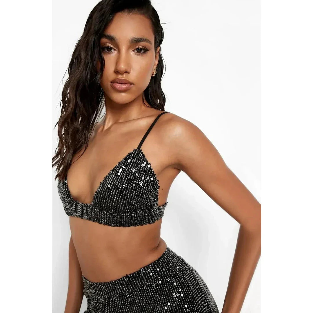 Elegant woman wearing a luxurious sequin top and pants set, perfect for a glamorous evening event