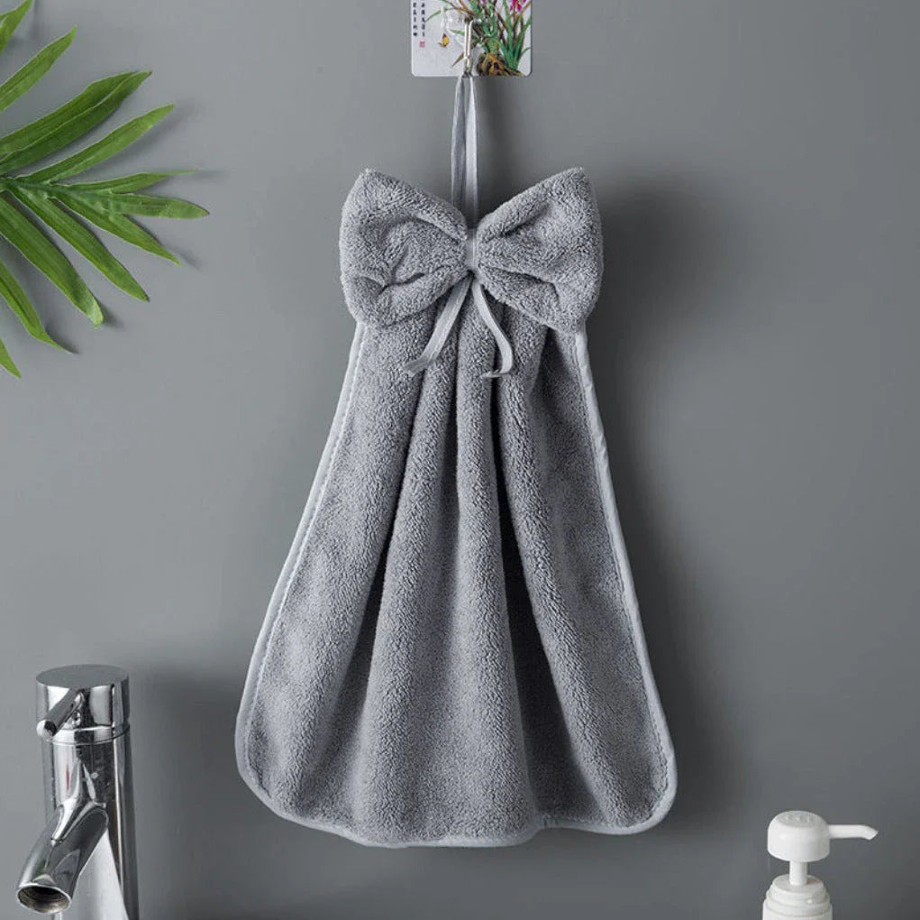 Elegant coral fleece hand towels with a unique bow design, perfect for kitchen and bathroom use