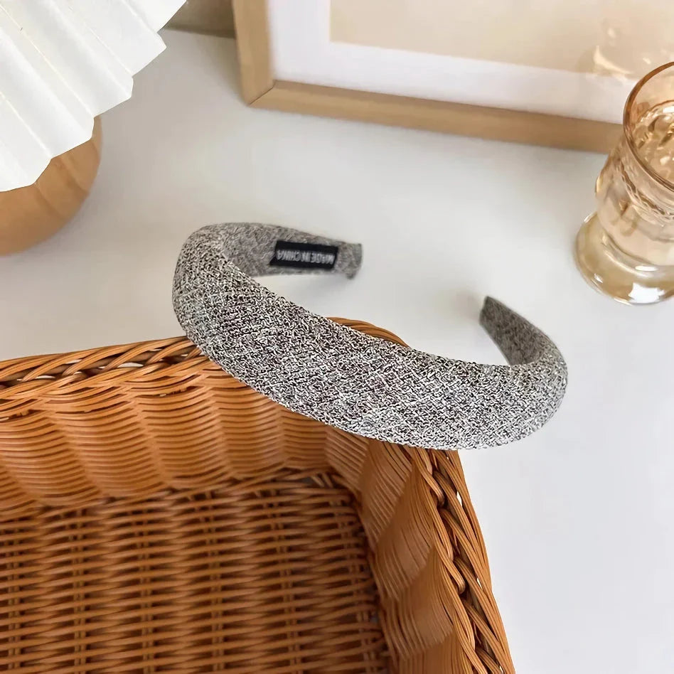 A stylish wide hairband in a classic plaid pattern, offering a chic and sophisticated look for British women.