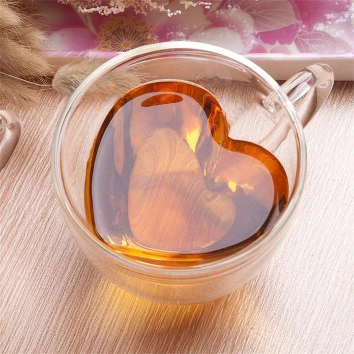 Elegant double heart-shaped ceramic mug in glass, perfect for enjoying hot beverages with a touch of British charm