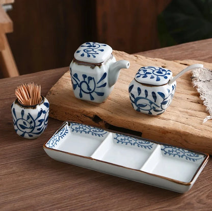 Premium four-piece ceramic seasoning set with oil, vinegar, seasoning, and toothpick holder for a stylish and organized kitchen