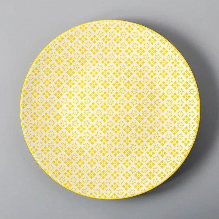 Elegant ceramic plates with vibrant, whimsical prints in a variety of enchanting designs