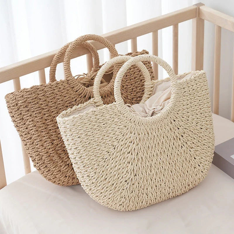 Premium handwoven straw beach tote with a casual half-moon shape and secure string closure, perfect for summer outings