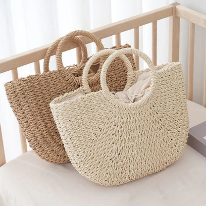 Premium handwoven straw beach tote with a casual half-moon shape and secure string closure, perfect for summer outings