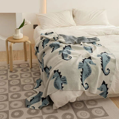 Soft and cosy 100% cotton blanket with a charming sea horse design, perfect for relaxation at home or on the go.