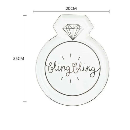 Elegant diamond ring-inspired porcelain dinnerware set with plate, bowl, and cup in a minimalist white colour