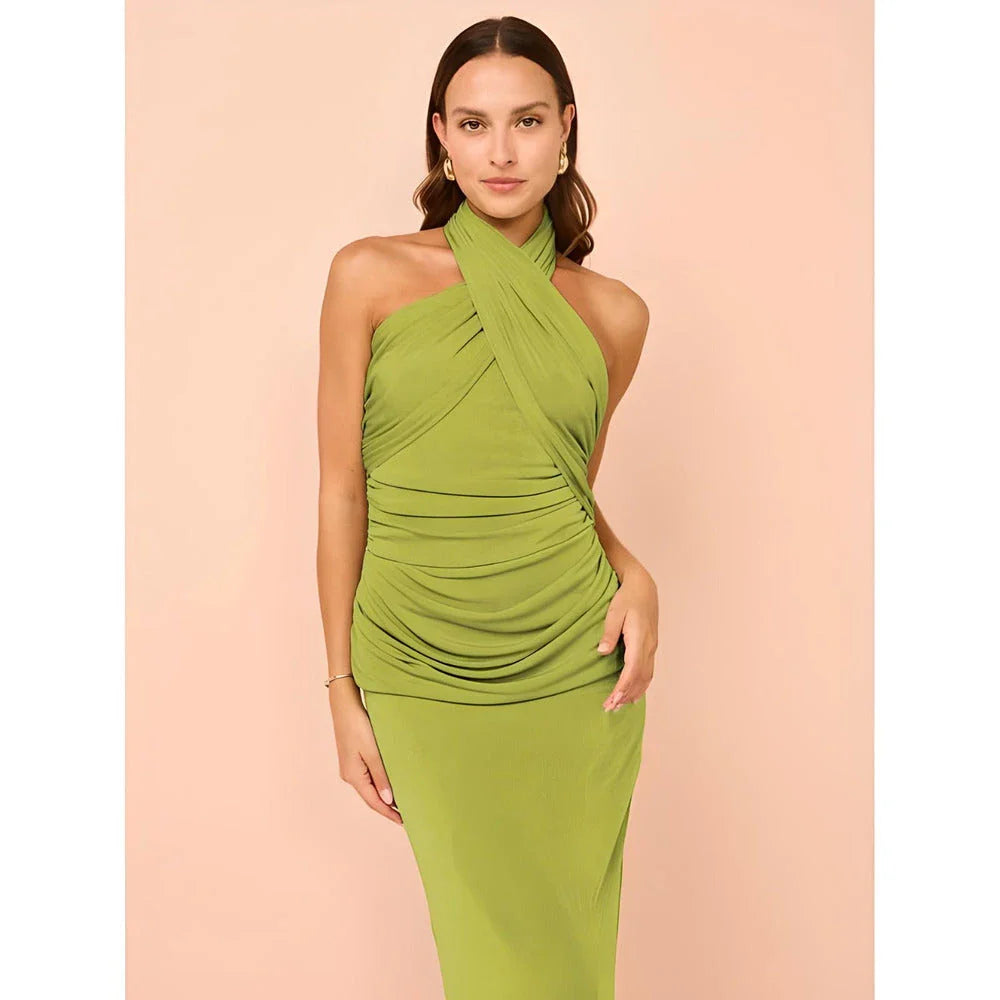 Elegant halter backless ankle-length bodycon dress in a solid colour, designed to flatter the figure and create a sophisticated, eye-catching look for formal events.