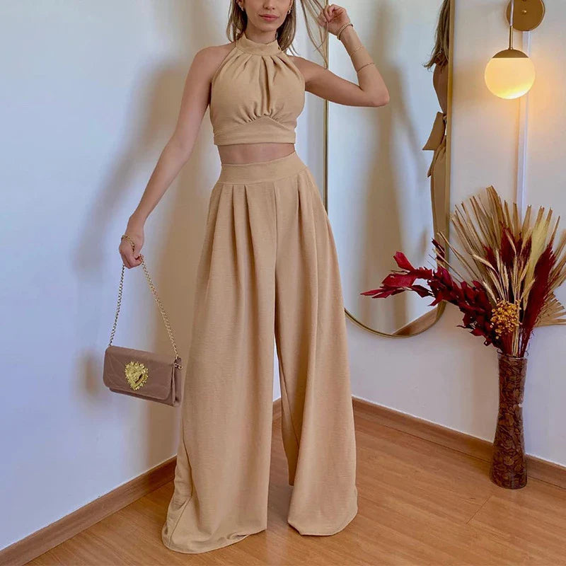 A stylish two-piece set with a halter-neck top and relaxed, high-waisted trousers in a range of sophisticated colours