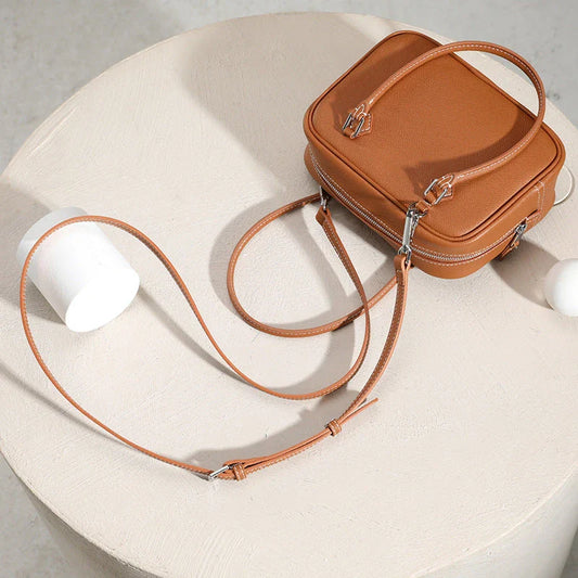 Elegant leather mini shoulder bag in a variety of colours, featuring a compact and versatile design for the stylish British woman.