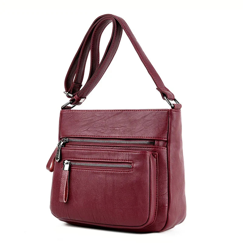 A stylish leather shoulder bag in a modern, box-style design, perfect for busy modern mums.