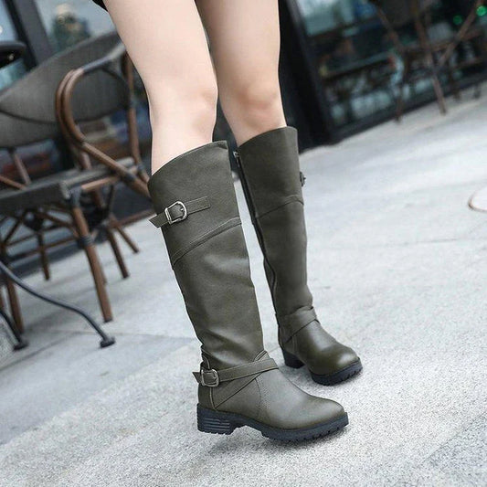 A pair of stylish women's low heel boots with a round toe design, available in black, brown, and army green colours.