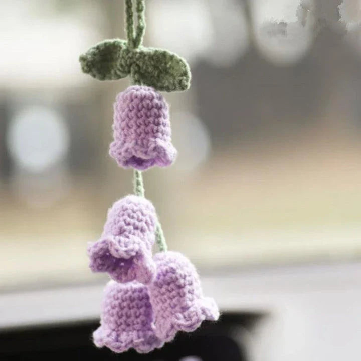 Charming knitted car plant decor with hanging white rope and green and white colour scheme