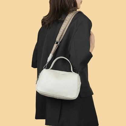 Luxurious genuine leather crossbody bag for women, featuring a soft polyester lining, dual phone pockets, and a compact, square design.